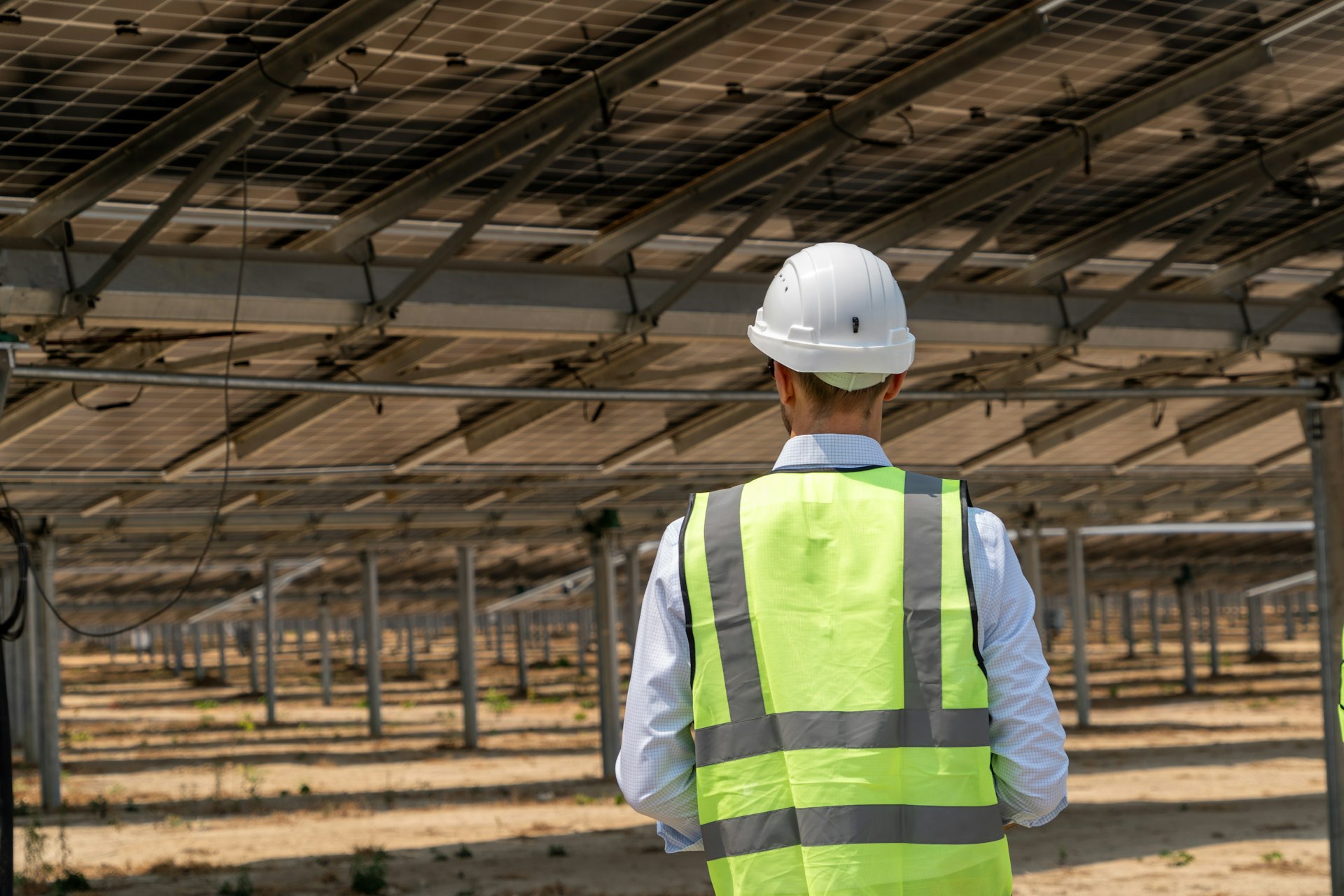 A man wearing a safety vest and hard hat